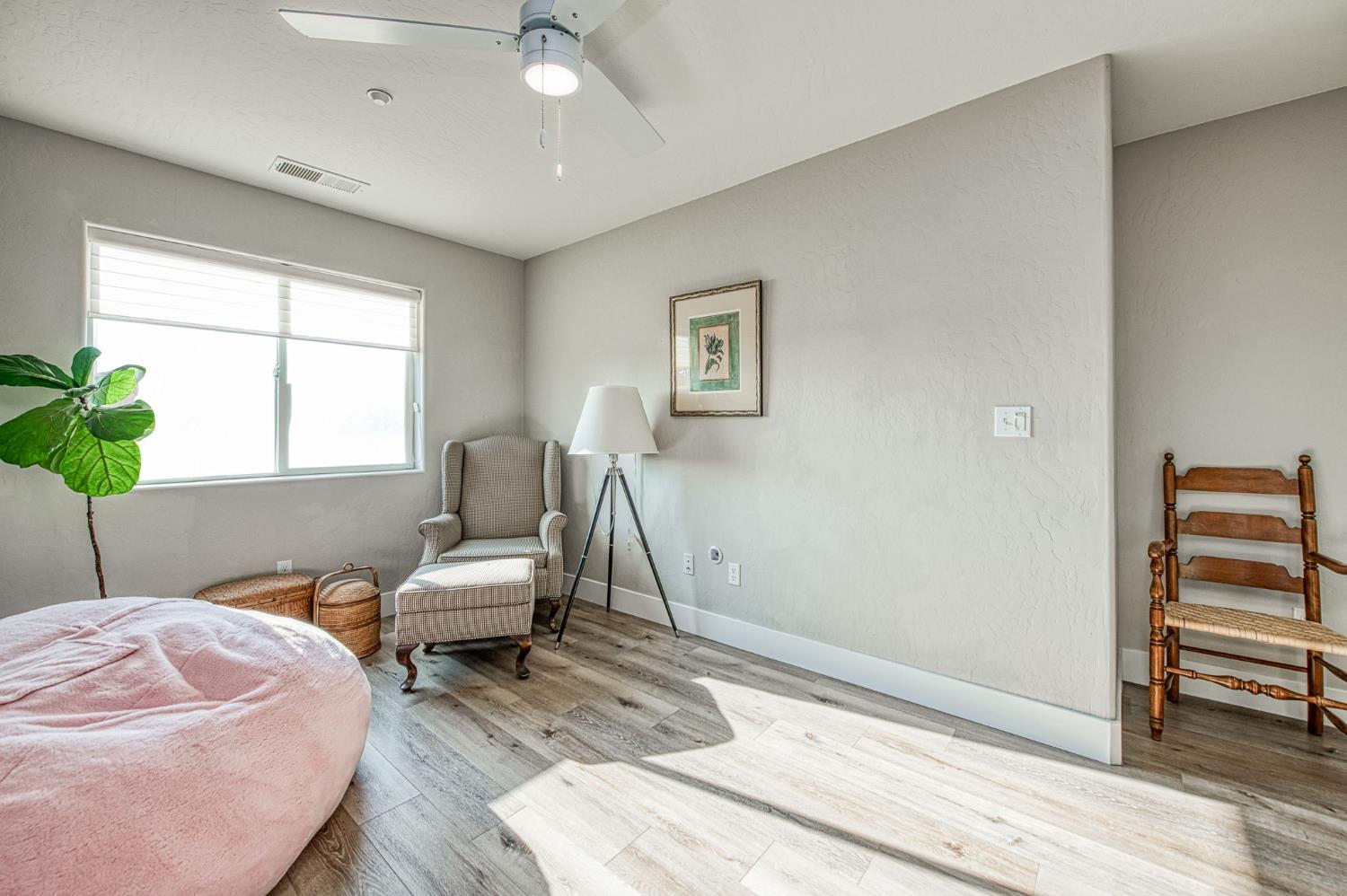 5855 East Platt Avenue Fresno, CA 93727 - Photo 55 of 57 a bedroom with a bed and a chair