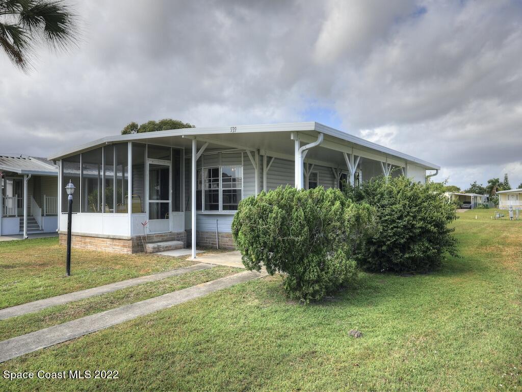 a view of a house with a yard and plants