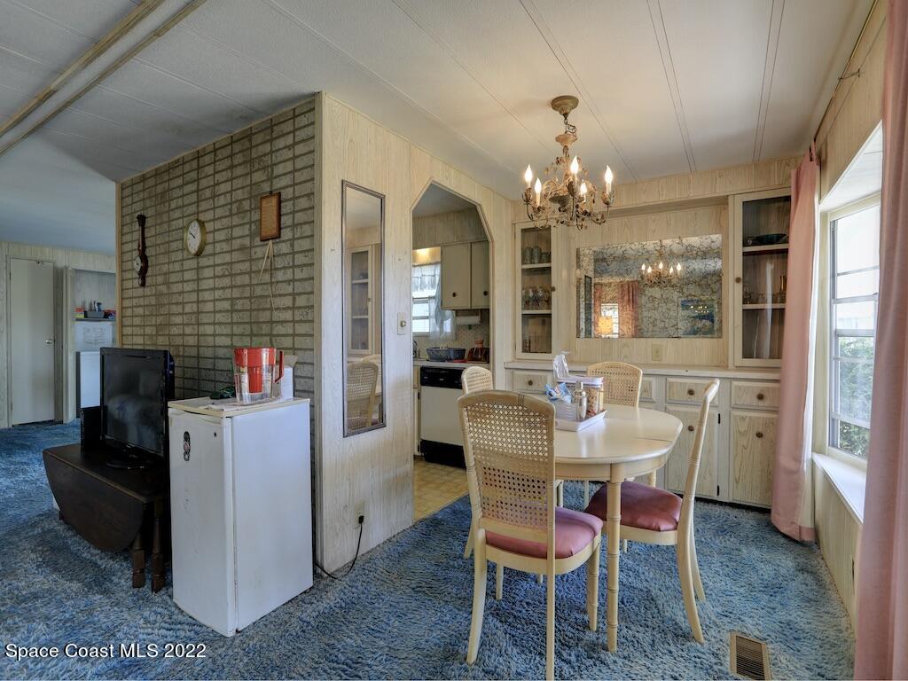 939 Laurel Circle Barefoot Bay, FL 32976 - Photo 15 of 36 a dining room with furniture a chandelier and window