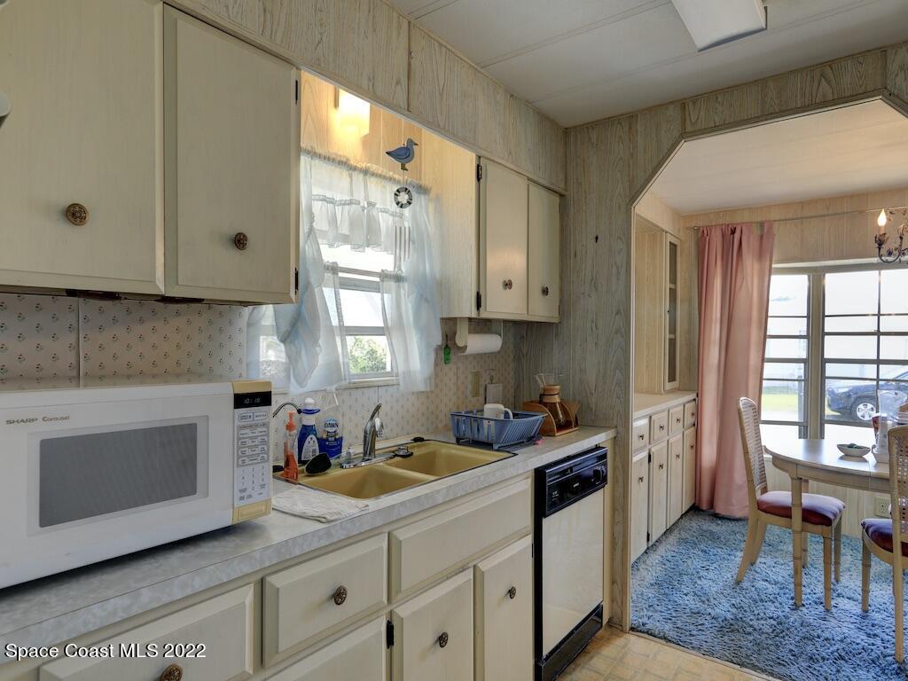 939 Laurel Circle Barefoot Bay, FL 32976 - Photo 16 of 36 a kitchen with a sink cabinets and window