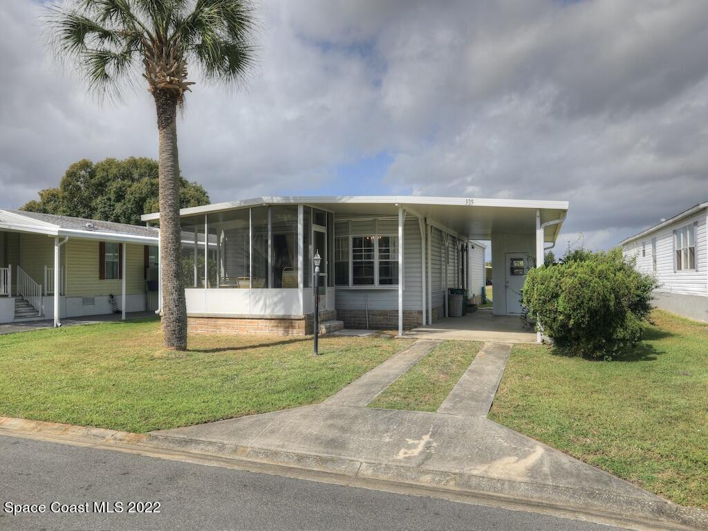 939 Laurel Circle Barefoot Bay, FL 32976 - Photo 2 of 36 a view of a house with a yard and plants