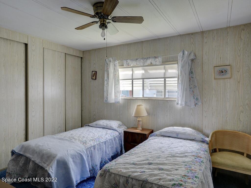 939 Laurel Circle Barefoot Bay, FL 32976 - Photo 25 of 36 a bedroom with two beds and painted walls