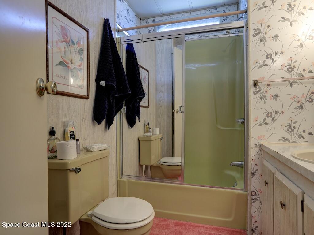 939 Laurel Circle Barefoot Bay, FL 32976 - Photo 27 of 36 a bathroom with a toilet and a shower