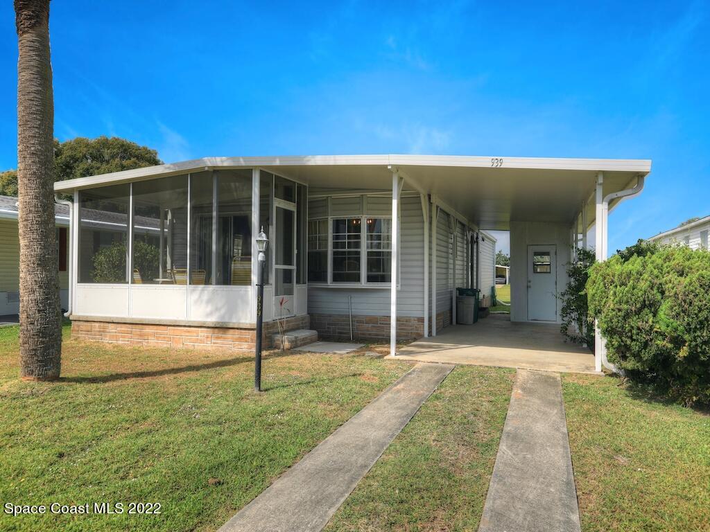 939 Laurel Circle Barefoot Bay, FL 32976 - Photo 3 of 36 a view of house with backyard and glass windows