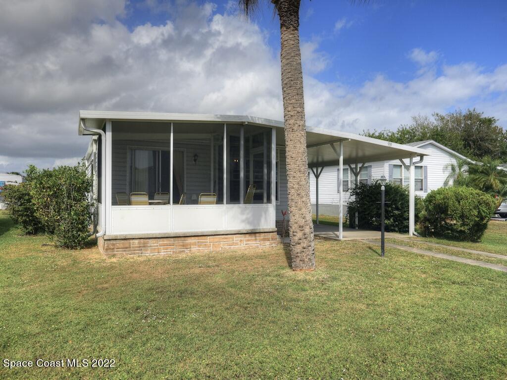 939 Laurel Circle Barefoot Bay, FL 32976 - Photo 4 of 36 a view of an house with backyard and garden