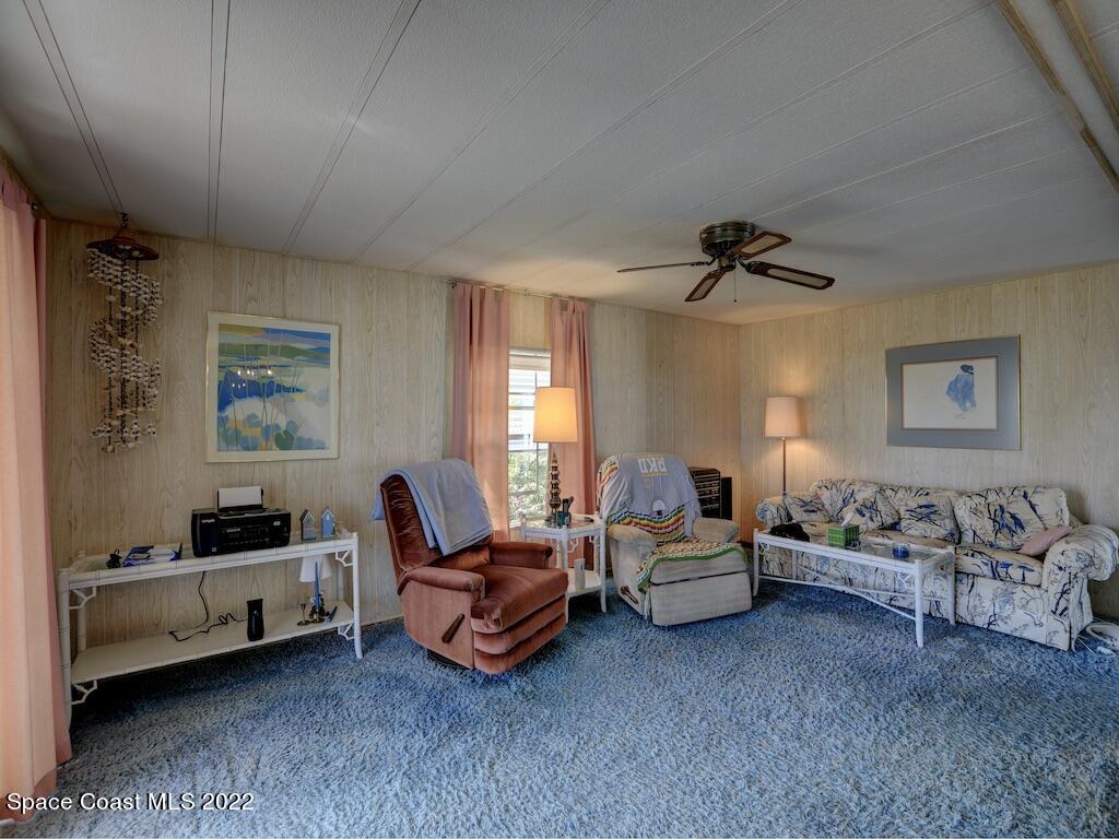 939 Laurel Circle Barefoot Bay, FL 32976 - Photo 10 of 36 a living room with furniture and a window