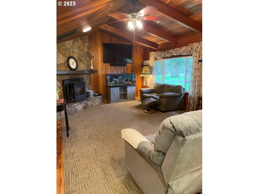 40553 Little Fall Creek Road Fall Creek, OR 97438 - Photo 9 of 28 a living room with furniture and a fireplace
