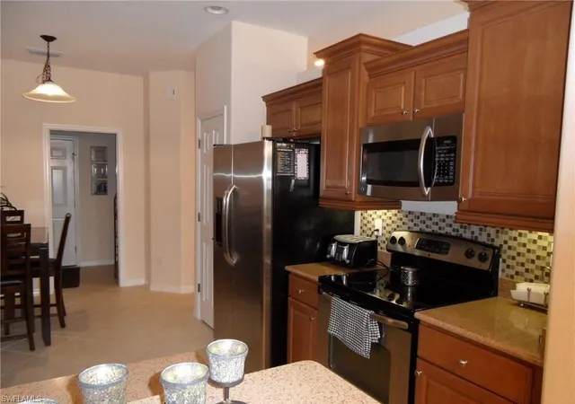 a kitchen with a refrigerator stove and microwave