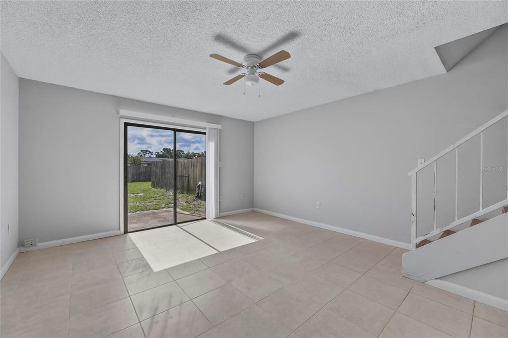 4799 Sisson Road Titusville, FL 32780 - Photo 11 of 23 a view of a livingroom with a ceiling fan and window