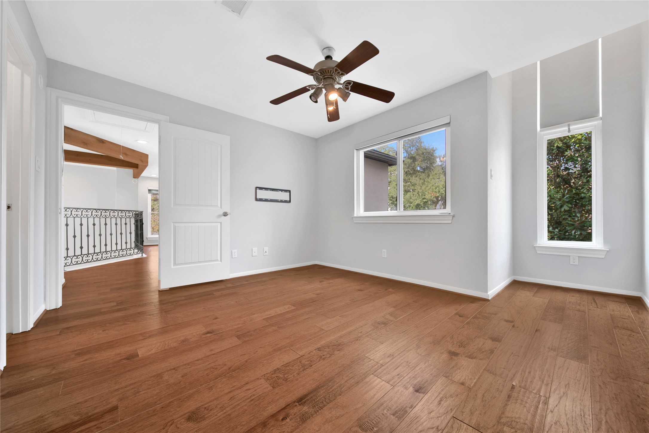 1937 Norfolk Street Houston, TX 77098 - Photo 36 of 41 a view of an empty room with wooden floor and a window