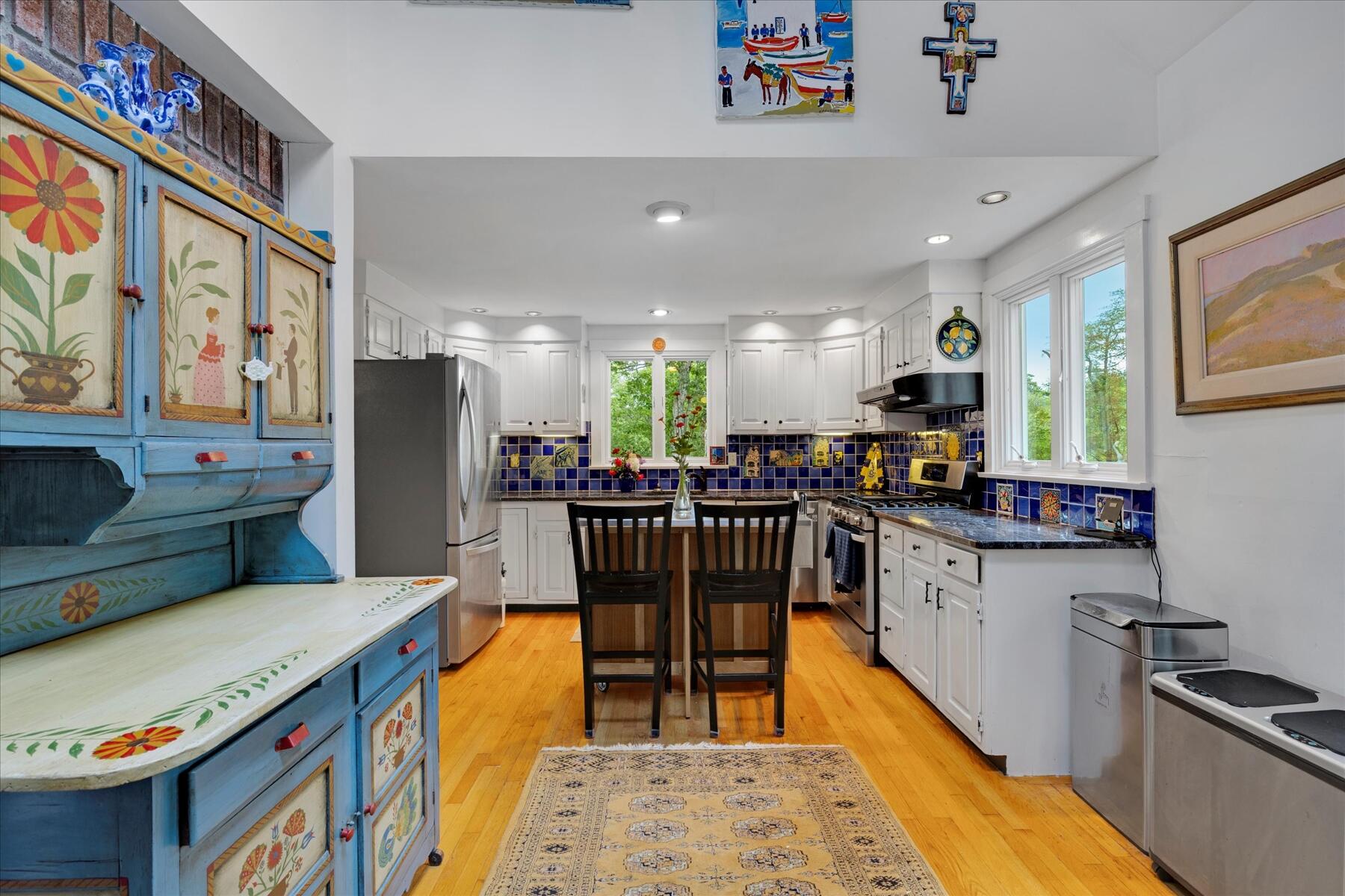 36 Cranberry Way Wellfleet, MA 02667 - Photo 11 of 64 a kitchen with stainless steel appliances granite countertop a sink a stove a refrigerator cabinets and living room view