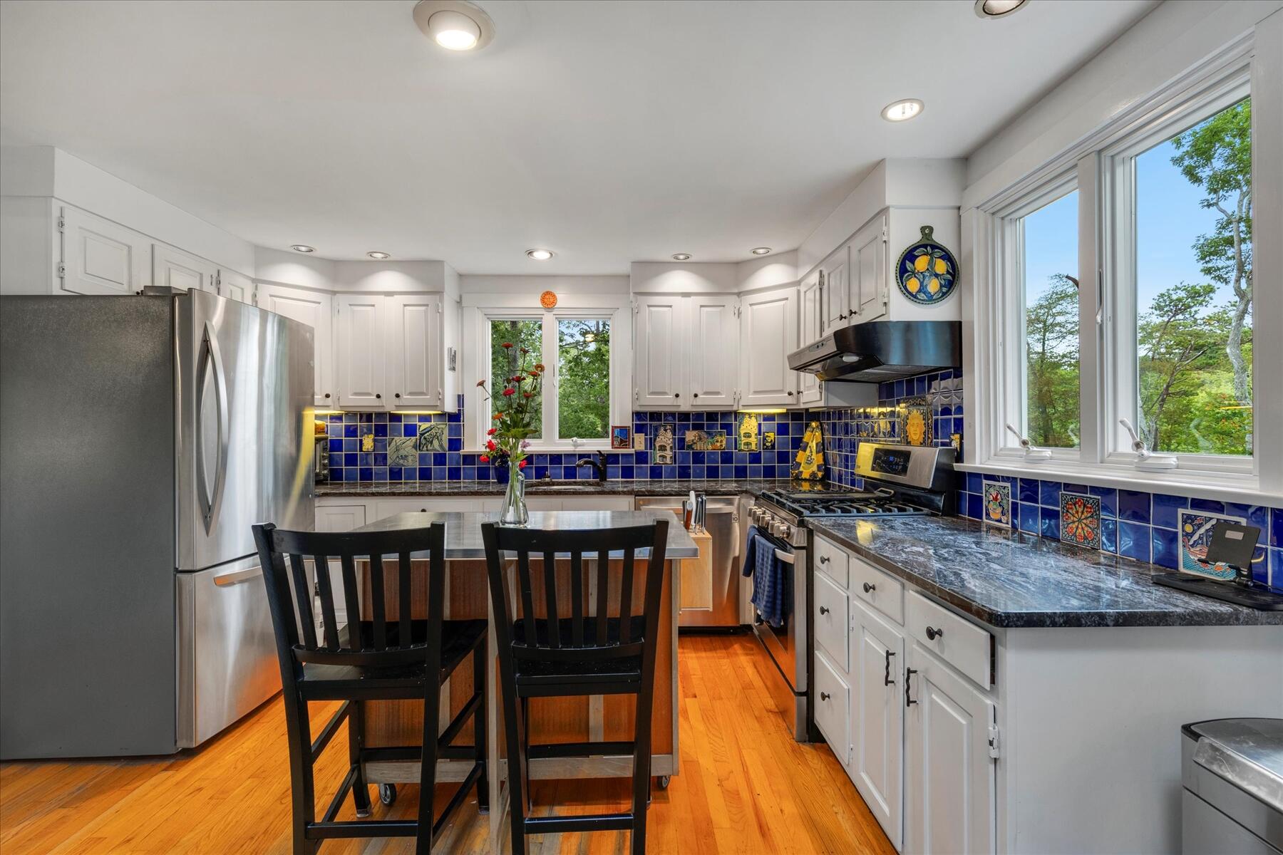 36 Cranberry Way Wellfleet, MA 02667 - Photo 12 of 64 a kitchen with stainless steel appliances granite countertop a stove a refrigerator a kitchen island and chairs in it