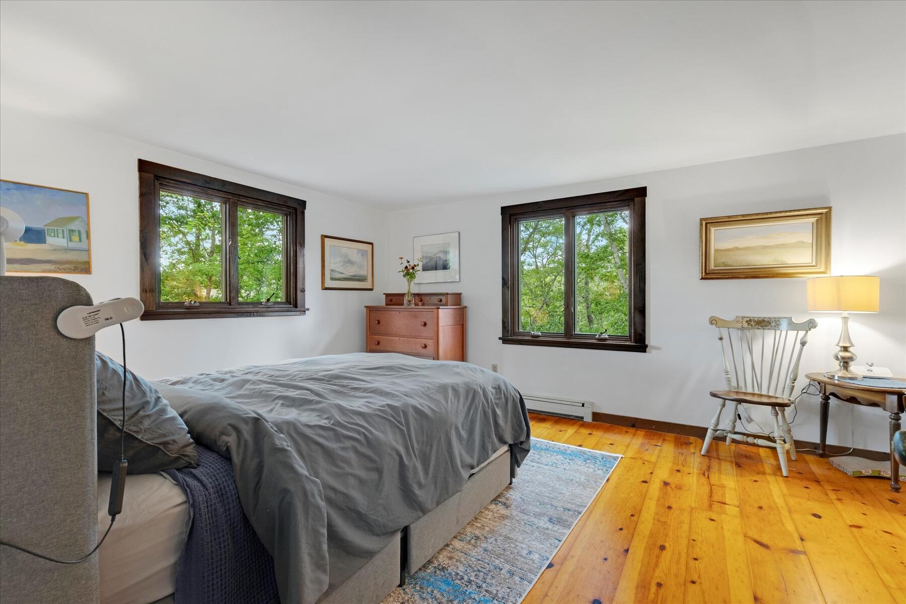 36 Cranberry Way Wellfleet, MA 02667 - Photo 28 of 64 a bedroom with a bed and wooden floor