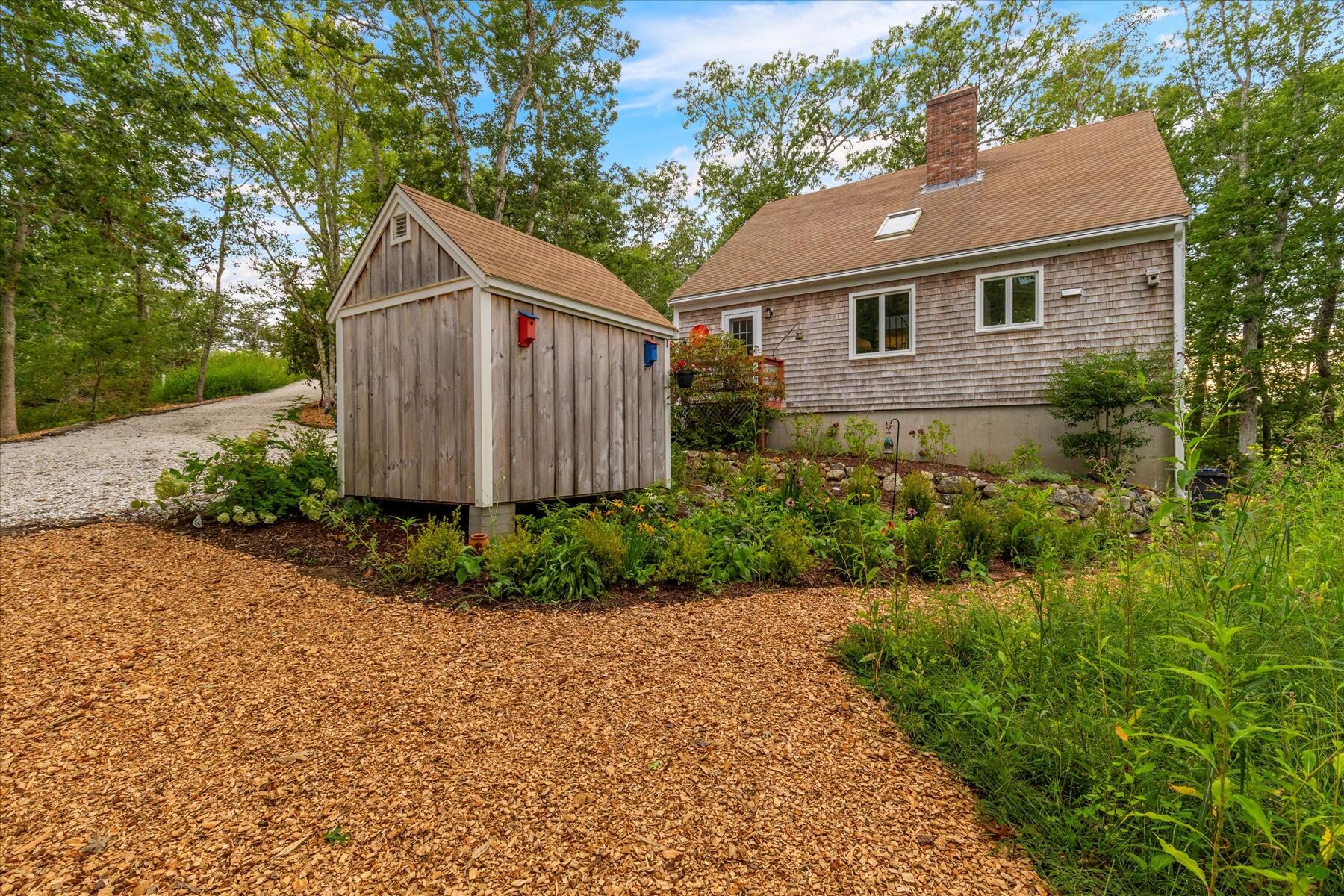 36 Cranberry Way Wellfleet, MA 02667 - Photo 46 of 64 a view of a small house with a yard plants and large tree
