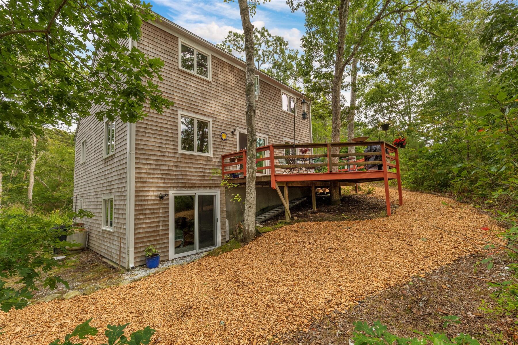 36 Cranberry Way Wellfleet, MA 02667 - Photo 6 of 64 a backyard of a house with table and chairs