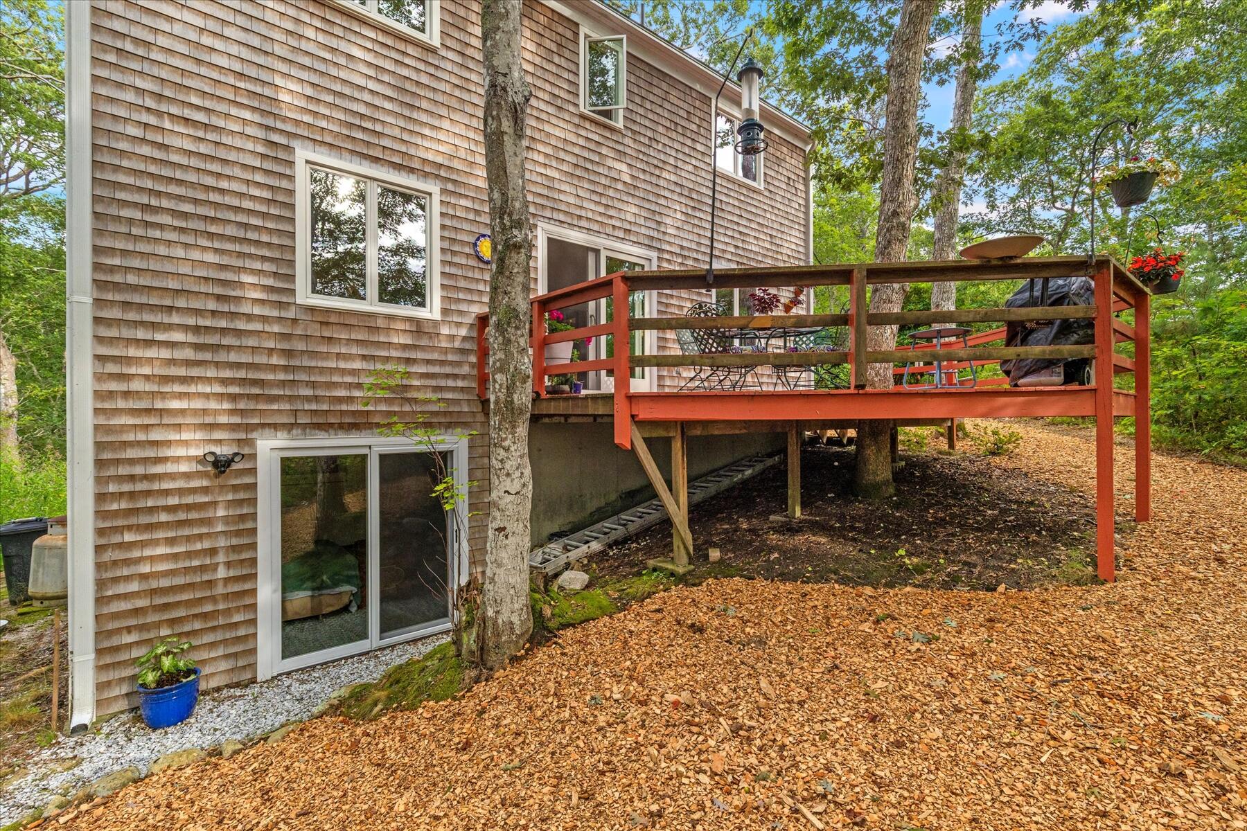 36 Cranberry Way Wellfleet, MA 02667 - Photo 7 of 64 a view of a house with a deck and a yard