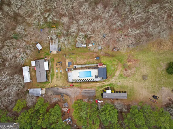 an aerial view of a house with yard and outdoor seating