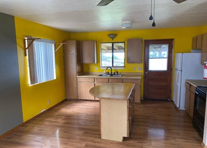 5702 Lower Kula Road Kula, HI 96790 - Photo 11 of 20 a kitchen with stainless steel appliances granite countertop a sink a stove and refrigerator