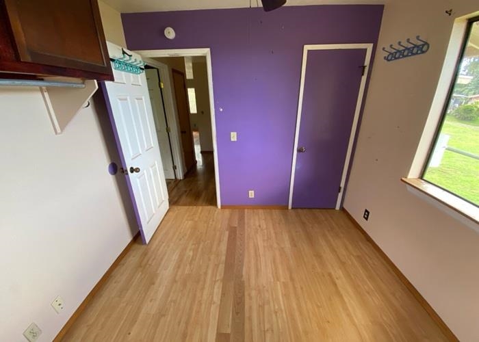 5702 Lower Kula Road Kula, HI 96790 - Photo 16 of 20 a view of a hallway with wooden floor and stairs