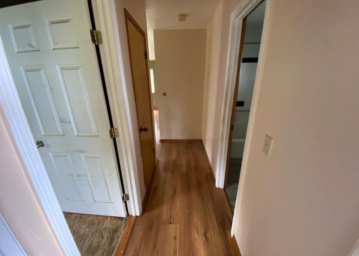 5702 Lower Kula Road Kula, HI 96790 - Photo 17 of 20 a view of a hallway with wooden floor and staircase
