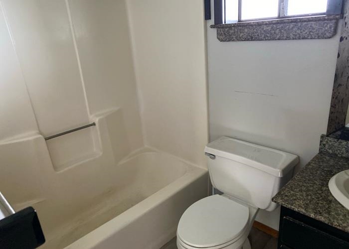 5702 Lower Kula Road Kula, HI 96790 - Photo 19 of 20 a white toilet sitting next to a bath tub