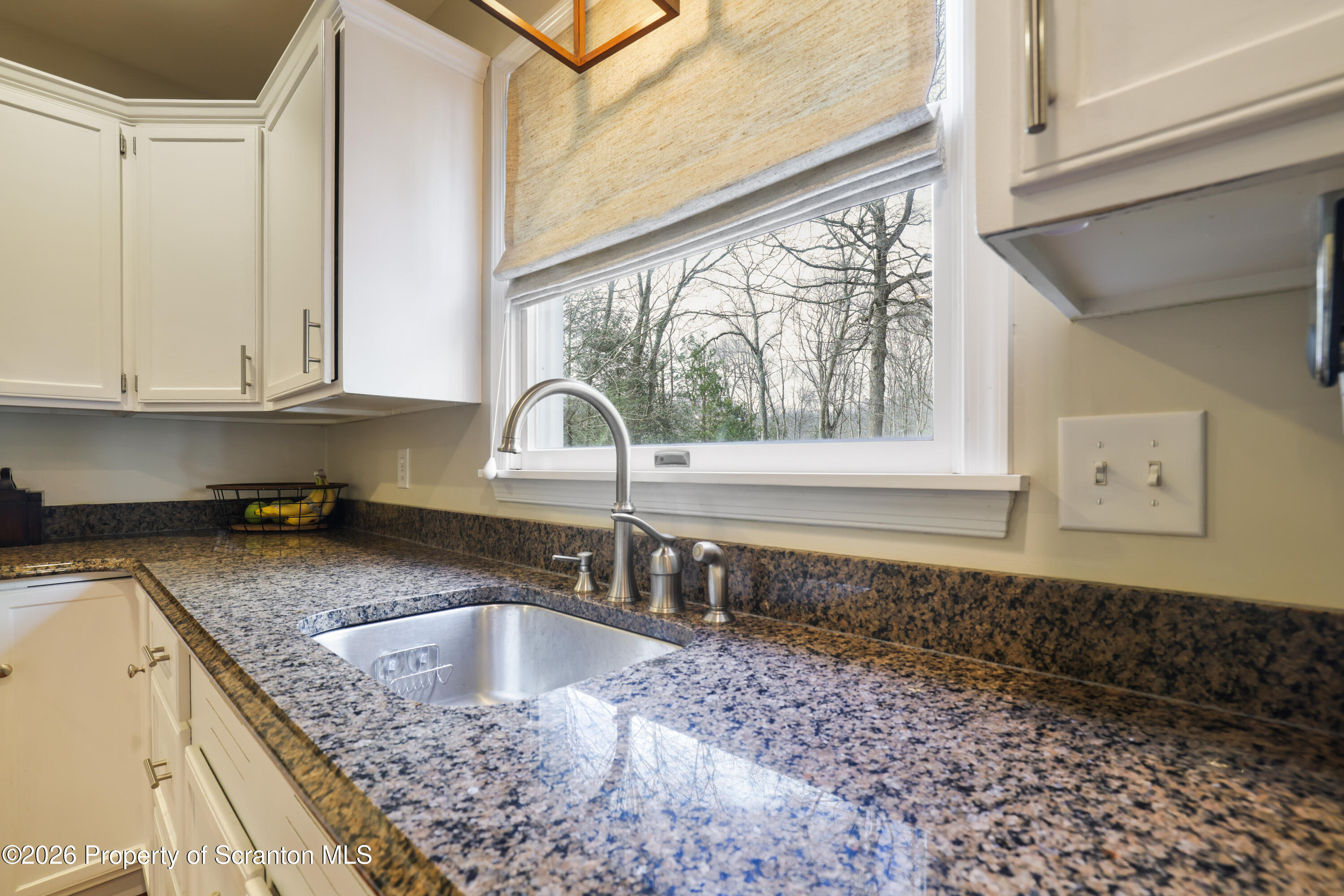 3 Old Mill Road Jermyn, PA 18433 - Photo 12 of 57 a kitchen with granite countertop a sink a counter top space and cabinets