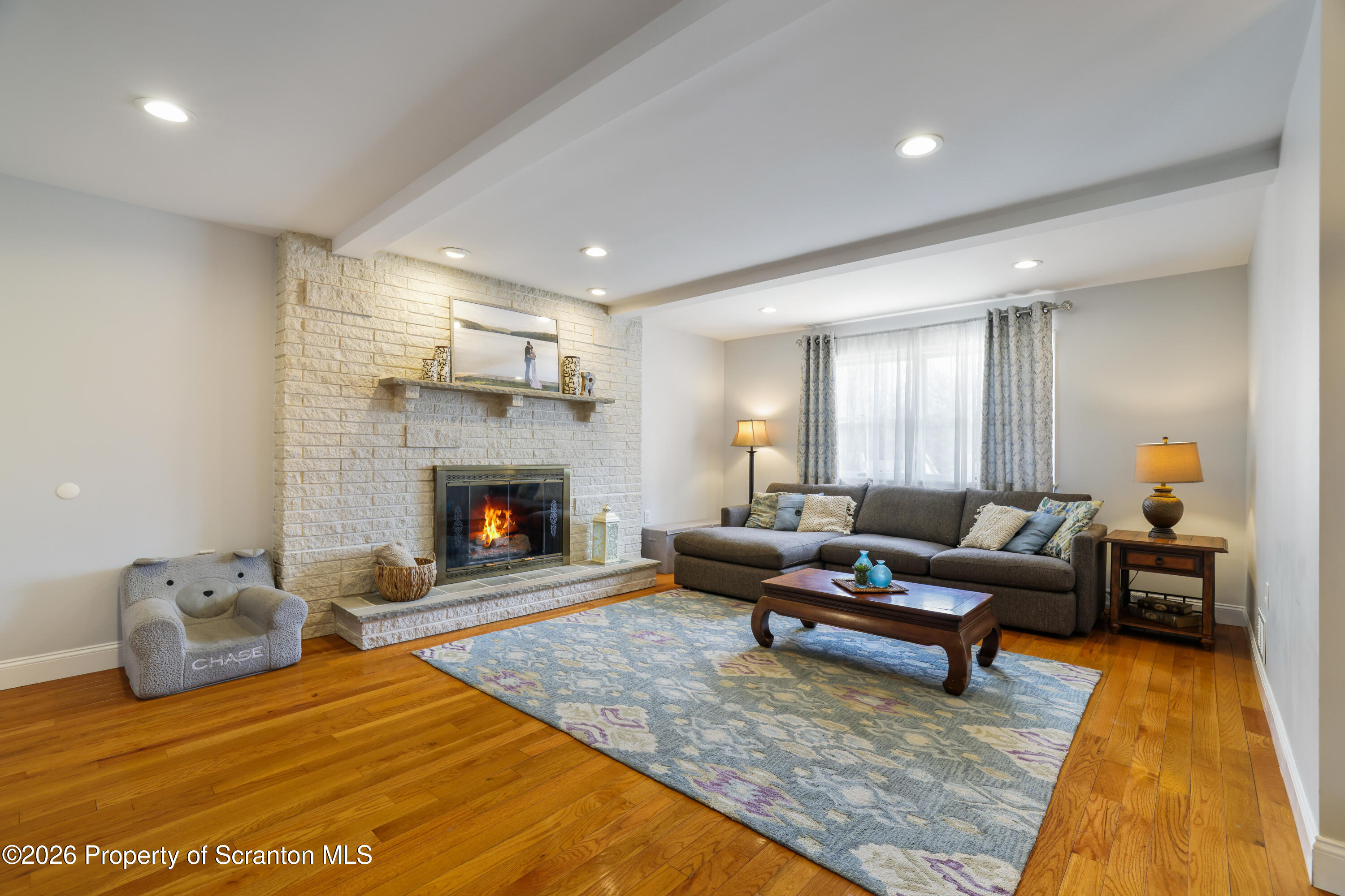 3 Old Mill Road Jermyn, PA 18433 - Photo 19 of 57 a living room with furniture and a fireplace