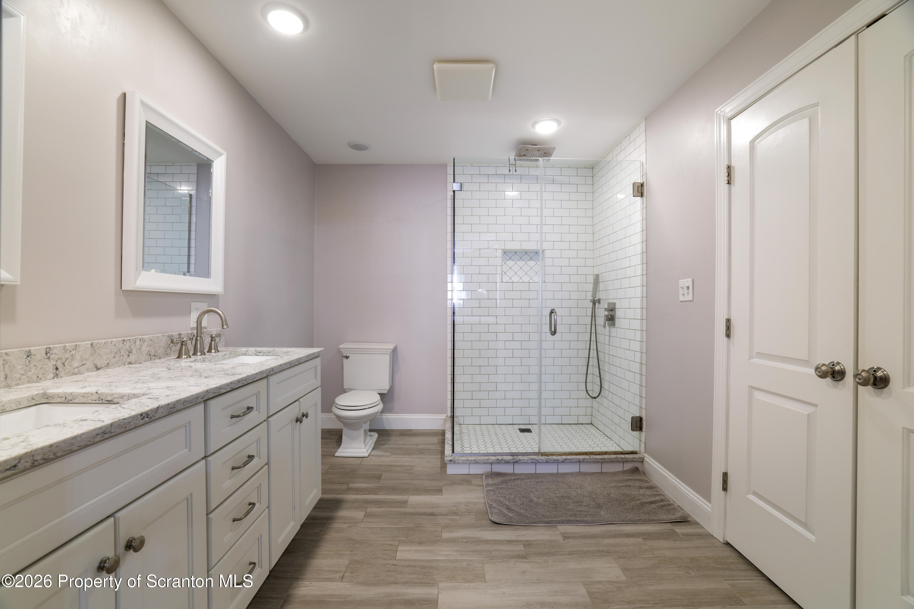 3 Old Mill Road Jermyn, PA 18433 - Photo 30 of 57 a bathroom with a granite countertop sink mirror and a toilet