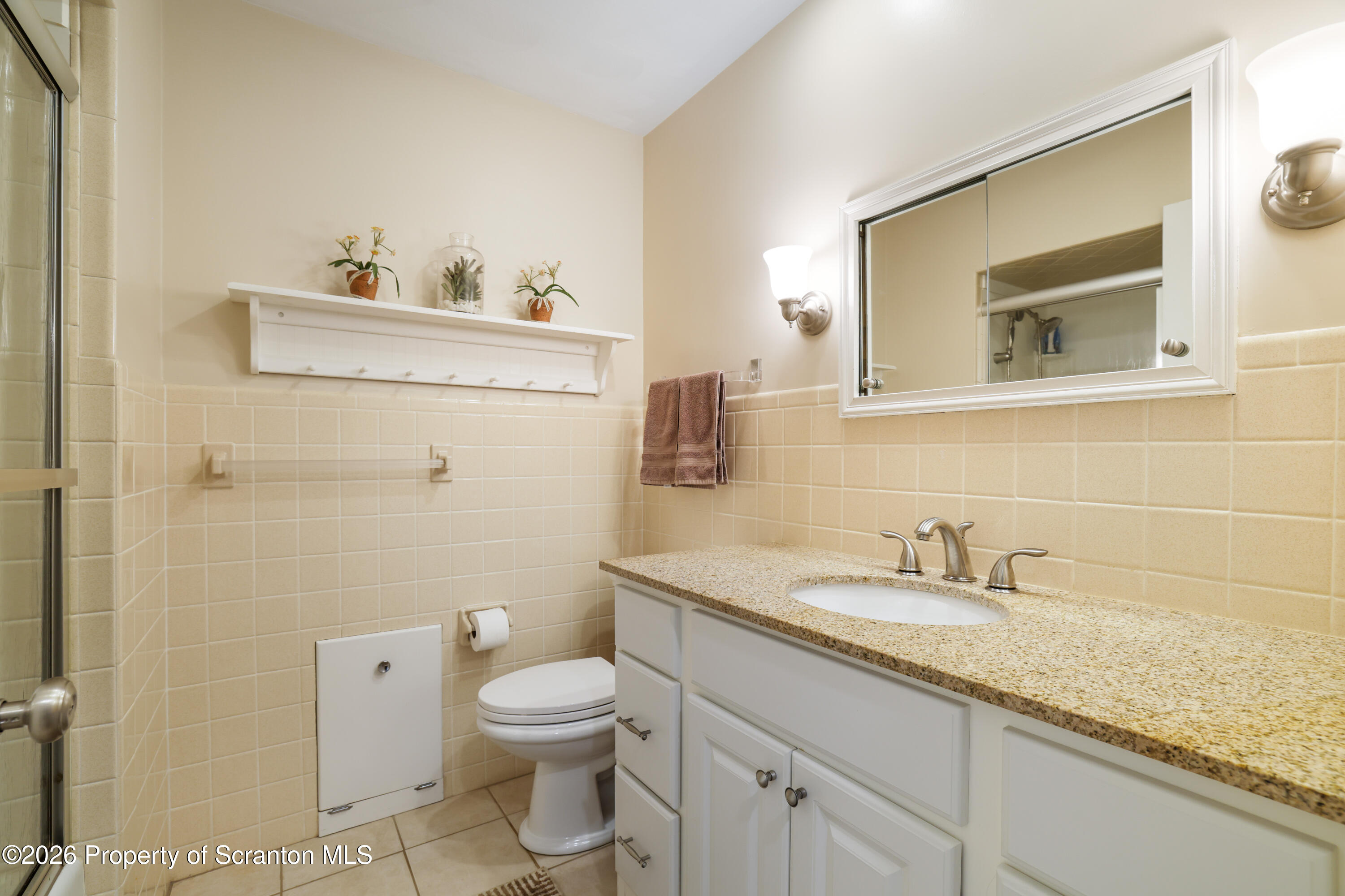 3 Old Mill Road Jermyn, PA 18433 - Photo 39 of 57 a bathroom with a granite countertop toilet sink and mirror