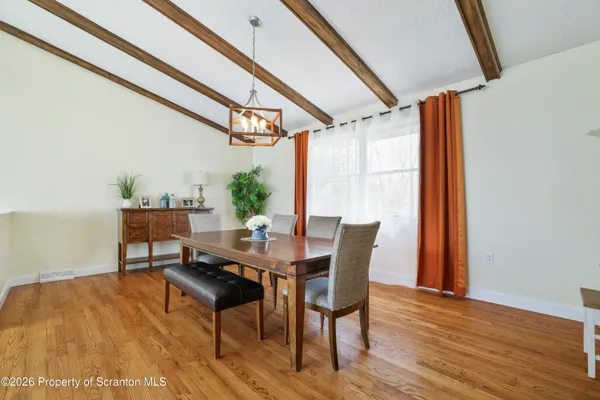 a view of a dining room with furniture and window