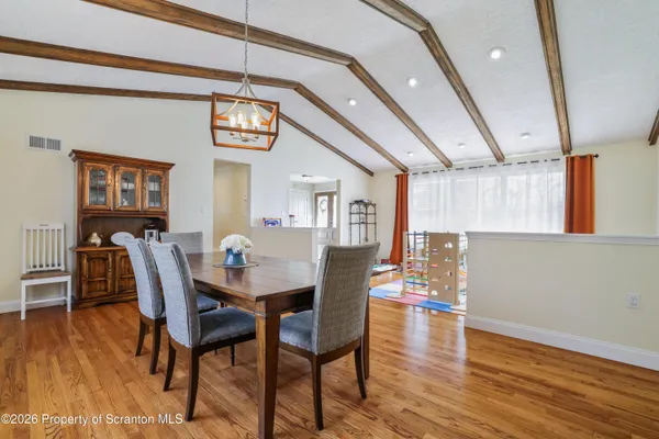 a view of a dining room with furniture and wooden floor