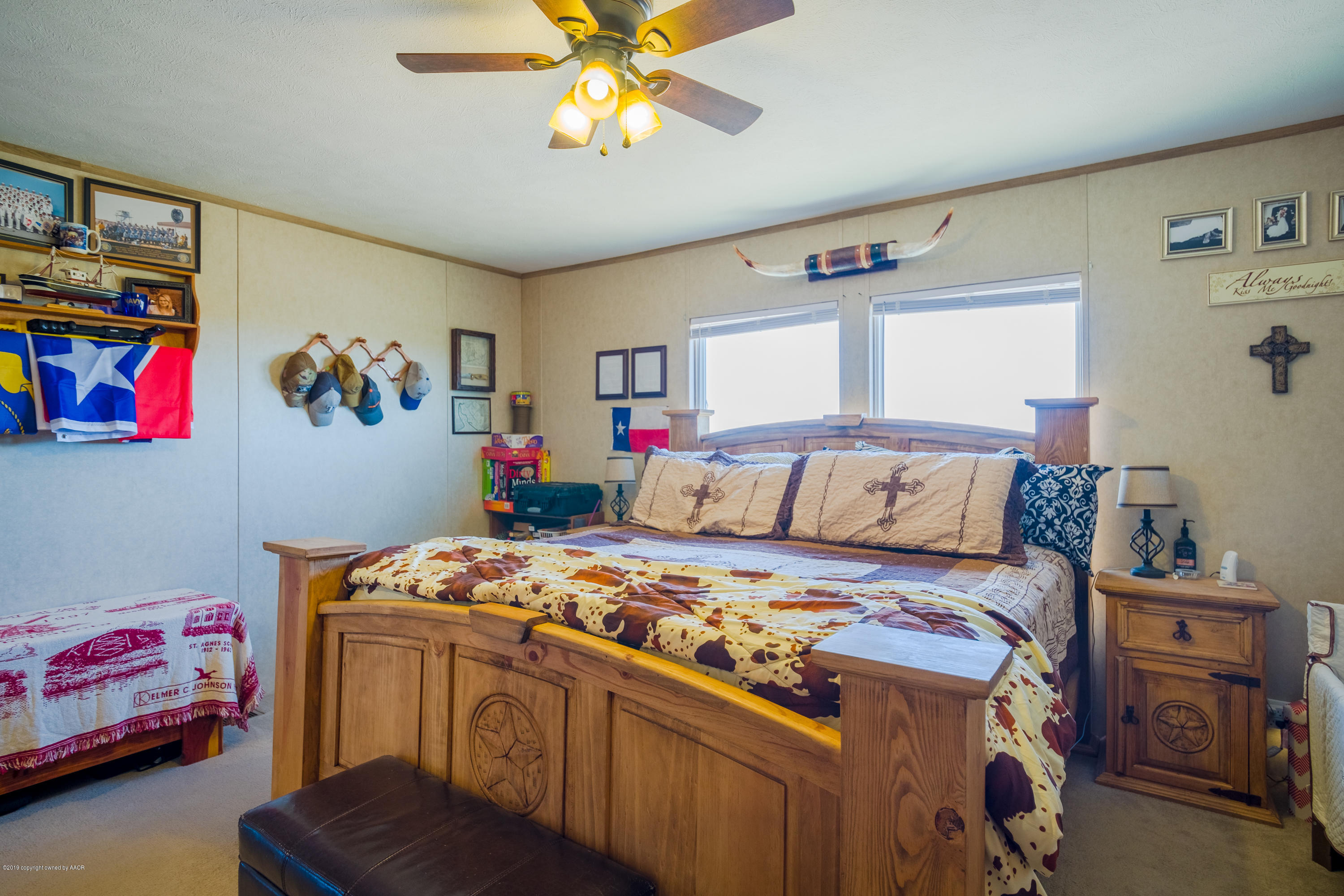 22300 Adkisson Road Canyon, TX 79015 - Photo 13 of 37 a bedroom with a bed and a chandelier