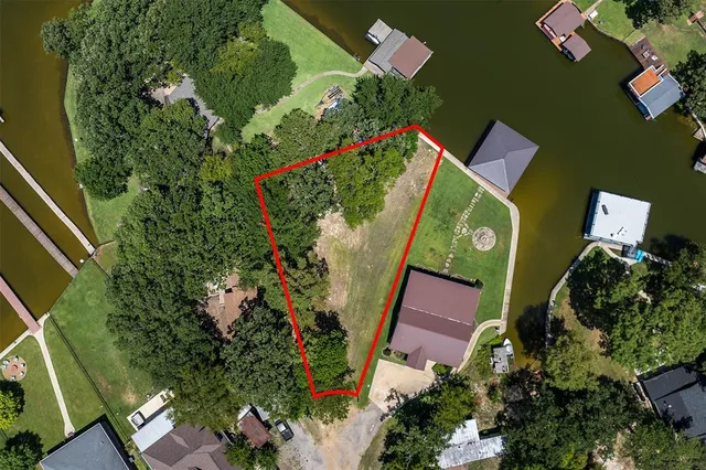 an aerial view of a house with a yard basket ball court and outdoor seating