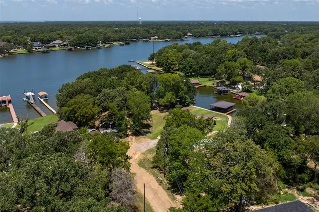 an aerial view of a house with a garden and lake view