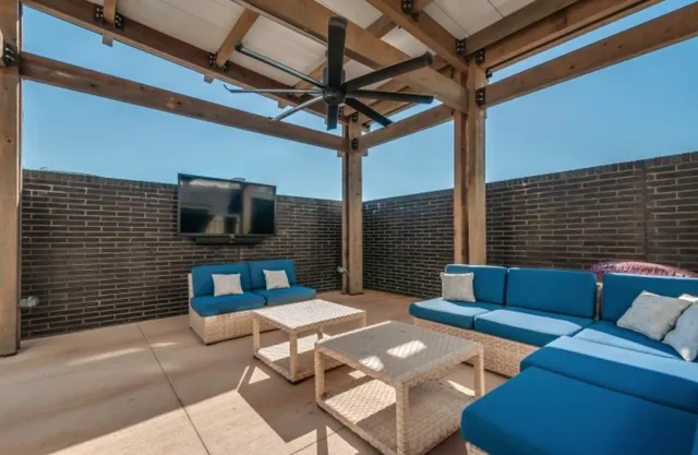 a view of a livingroom with furniture and flat screen tv