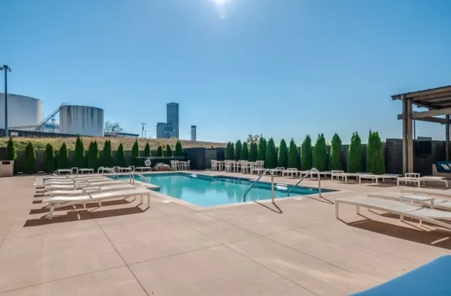 a view of a swimming pool and lounge chairs in patio