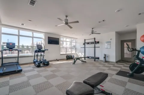 a view of a room with gym equipment and a large window