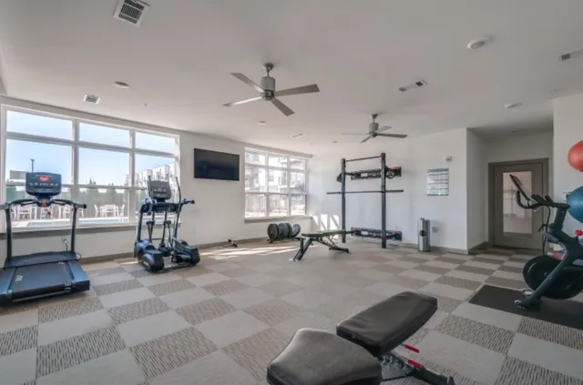 a view of a room with gym equipment and a large window