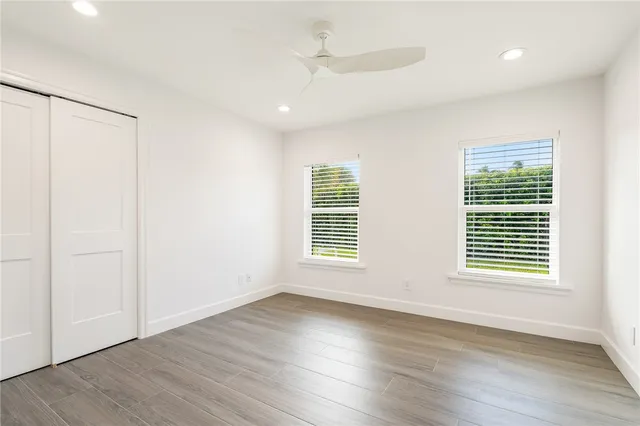 a bathroom with a granite countertop sink toilet and mirror