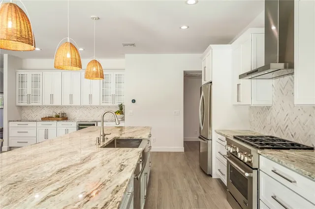 a kitchen with a stove a sink and a refrigerator