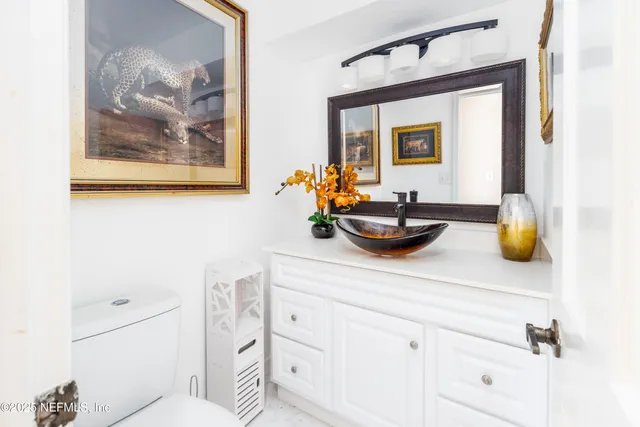 a bathroom with a sink mirror and vanity