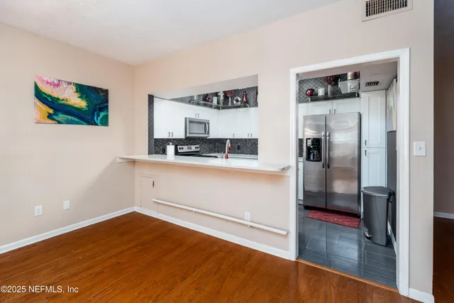 a kitchen with stainless steel appliances granite countertop a refrigerator and a sink