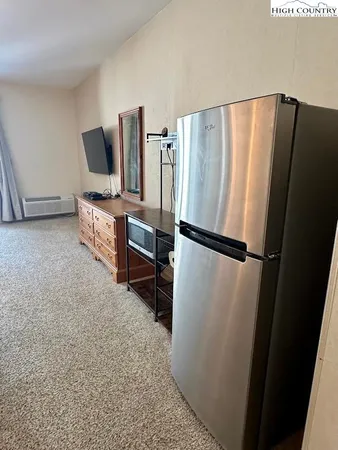 a kitchen with a refrigerator and a stove top oven