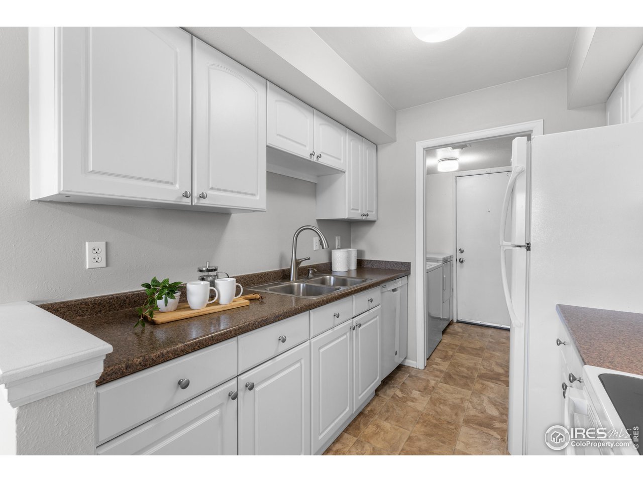 1170 Monroe Drive, Unit C Boulder, CO 80303 - Photo 6 of 14 a kitchen with granite countertop a sink stainless steel appliances and cabinets