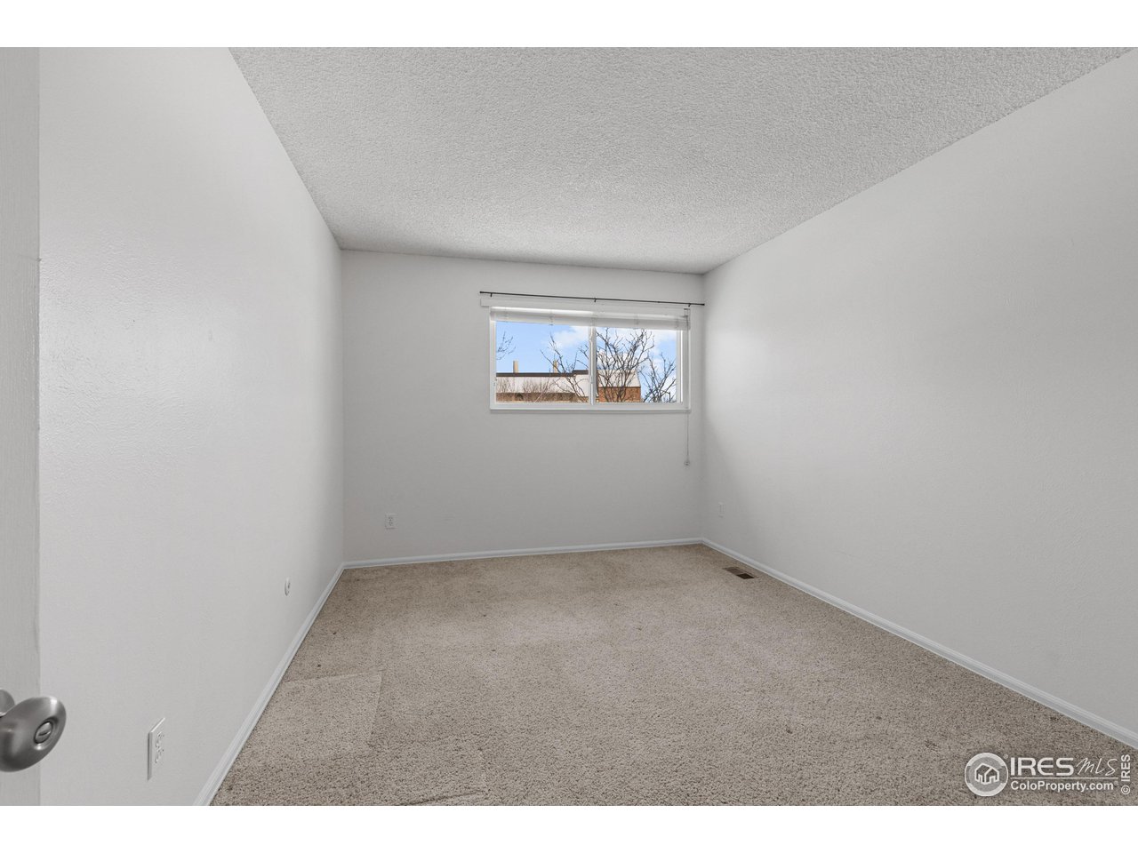 1170 Monroe Drive, Unit C Boulder, CO 80303 - Photo 10 of 14 a view of an empty room with a window