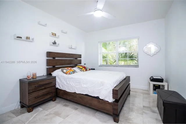 a bed sitting in a bedroom next to a window