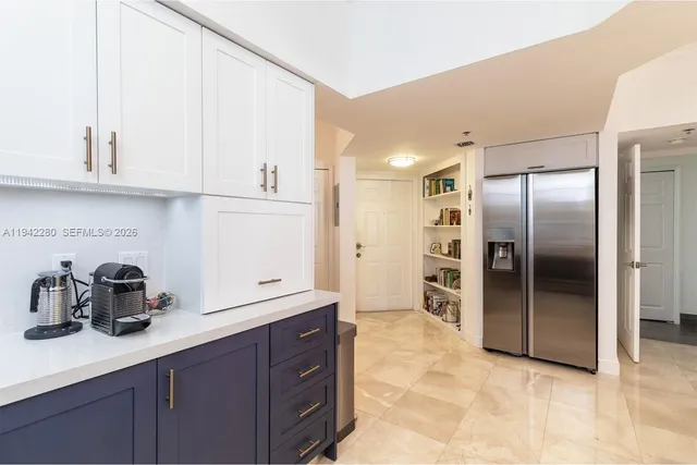 a kitchen with stainless steel appliances a sink and cabinets