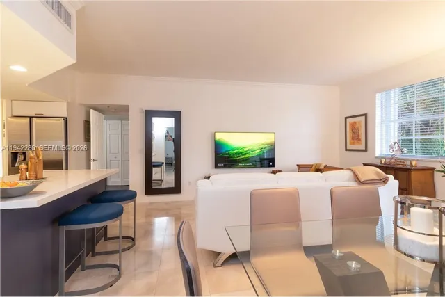 a living room with furniture a large window and a flat screen tv