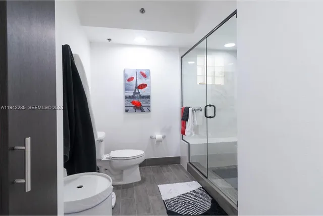 a bathroom with a toilet and a shower