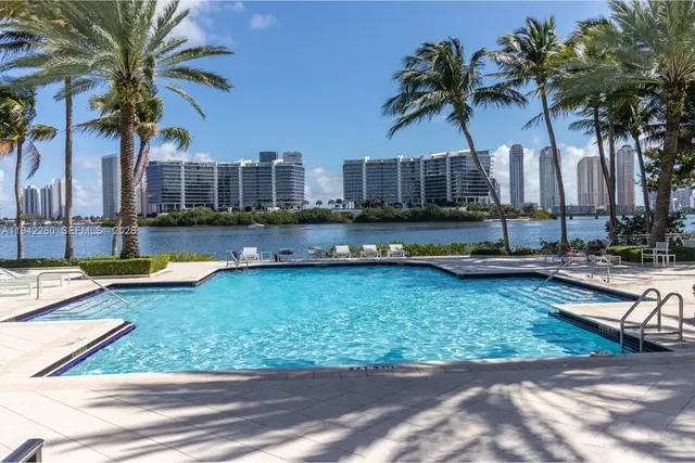 a front view of a house with swimming pool yard and outdoor seating